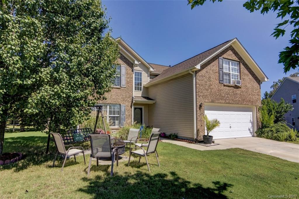 7467 Fallen Timber Lane, Unit 27 Tega Cay, SC 29708 - Photo 2 of 24 a backyard of a house with table and chairs