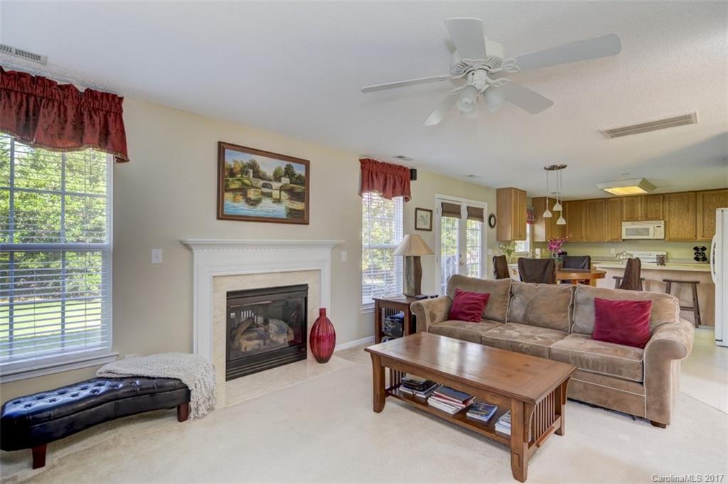 7467 Fallen Timber Lane, Unit 27 Tega Cay, SC 29708 - Photo 12 of 24 a living room with furniture and a fireplace