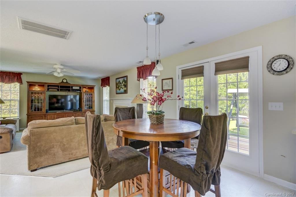 7467 Fallen Timber Lane, Unit 27 Tega Cay, SC 29708 - Photo 13 of 24 a view of a dining room with furniture window and outside view