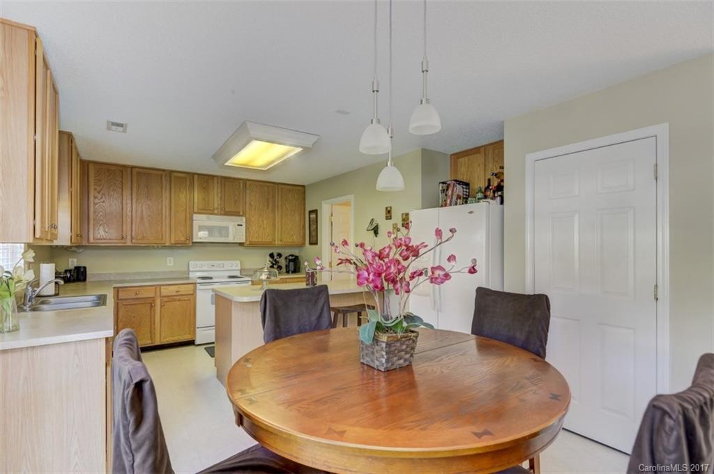 7467 Fallen Timber Lane, Unit 27 Tega Cay, SC 29708 - Photo 15 of 24 a view of a dining room with furniture