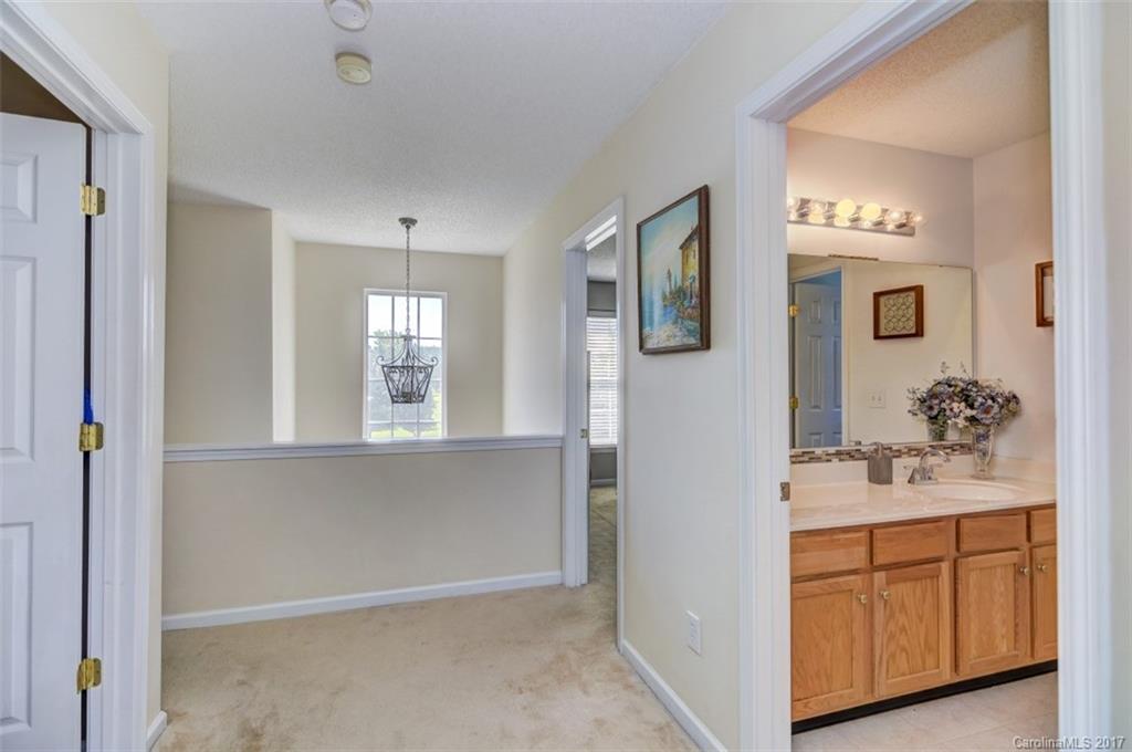 7467 Fallen Timber Lane, Unit 27 Tega Cay, SC 29708 - Photo 20 of 24 a bathroom with a sink vanity and mirror