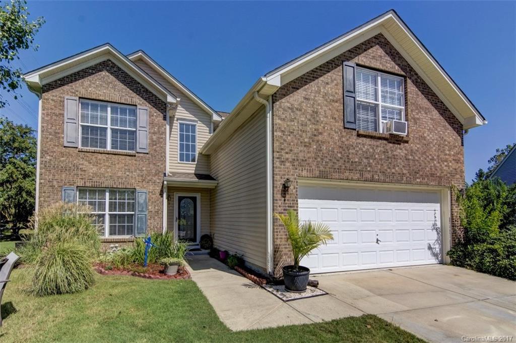 7467 Fallen Timber Lane, Unit 27 Tega Cay, SC 29708 - Photo 3 of 24 a front view of a house with garden