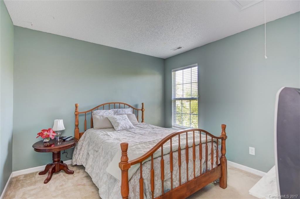 7467 Fallen Timber Lane, Unit 27 Tega Cay, SC 29708 - Photo 21 of 24 a bedroom with a bed and a window