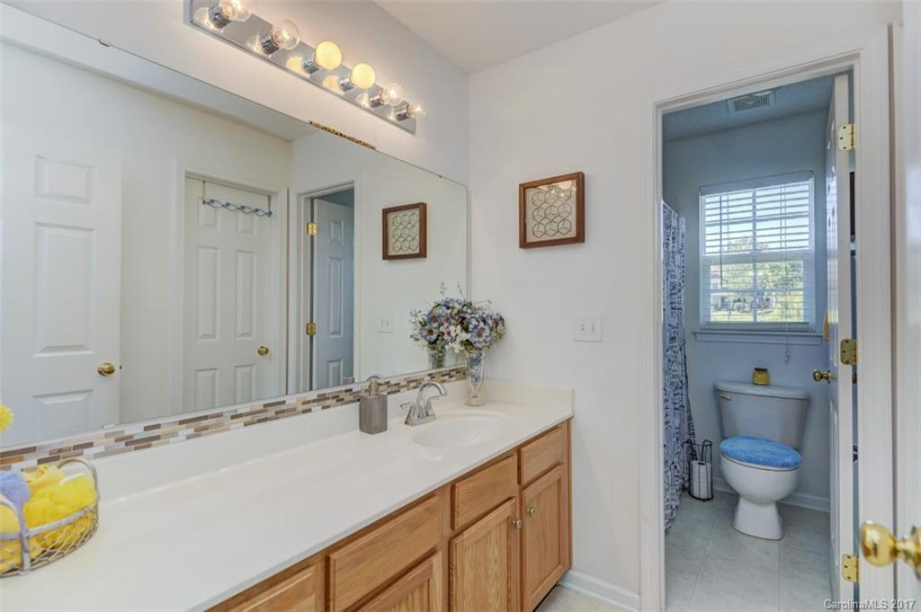 7467 Fallen Timber Lane, Unit 27 Tega Cay, SC 29708 - Photo 24 of 24 a bathroom with a sink and a large mirror