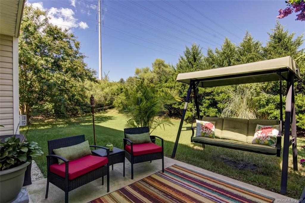 7467 Fallen Timber Lane, Unit 27 Tega Cay, SC 29708 - Photo 5 of 24 a view of a chairs and tables in the backyard