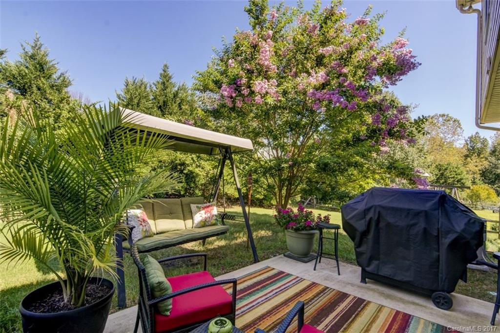 7467 Fallen Timber Lane, Unit 27 Tega Cay, SC 29708 - Photo 6 of 24 a view of a chairs and table in the backyard
