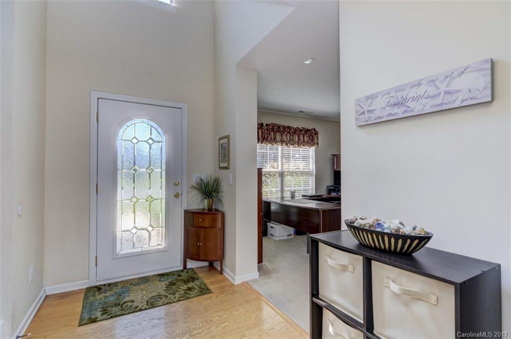 7467 Fallen Timber Lane, Unit 27 Tega Cay, SC 29708 - Photo 8 of 24 a hallway with a dresser and a mirror