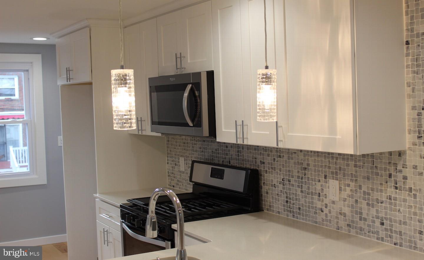 1244 Elson Road Brookhaven, PA 19015 - Photo 7 of 20 a kitchen with stainless steel appliances a stove a sink and a microwave