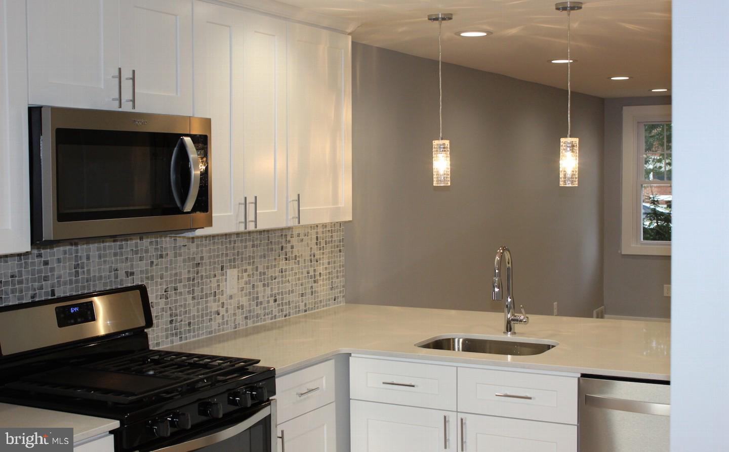 1244 Elson Road Brookhaven, PA 19015 - Photo 10 of 20 a kitchen with kitchen island granite countertop a sink stainless steel appliances and cabinets