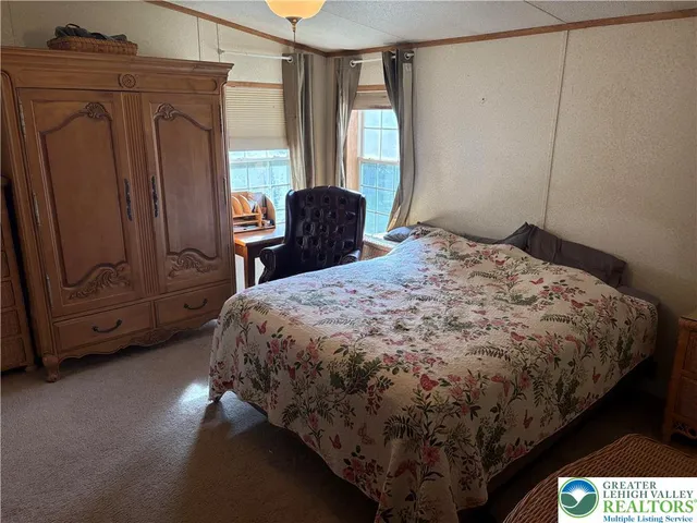 a bed sitting in a bedroom next to a window