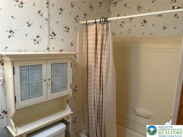 a bathroom with a tub and shower