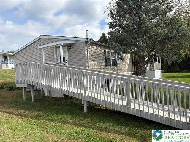 a view of a house with a wooden deck