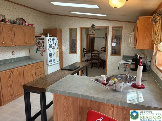 a kitchen with a table chairs and wooden floor