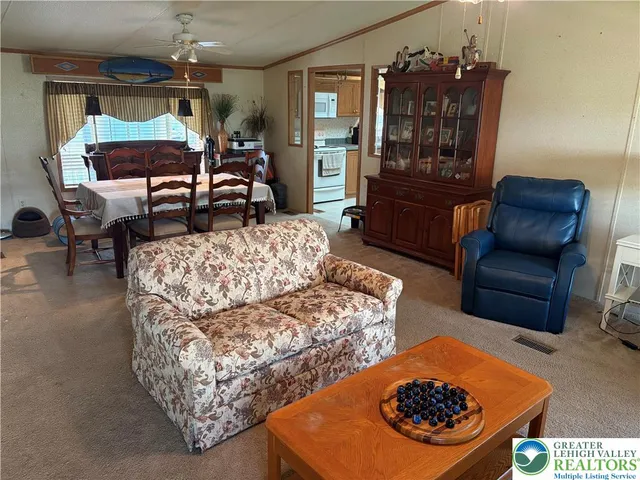 a living room with furniture a rug and a chandelier