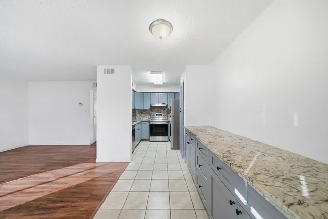 a kitchen with granite countertop cabinets and oven