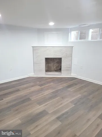 a view of an empty room and wooden floor