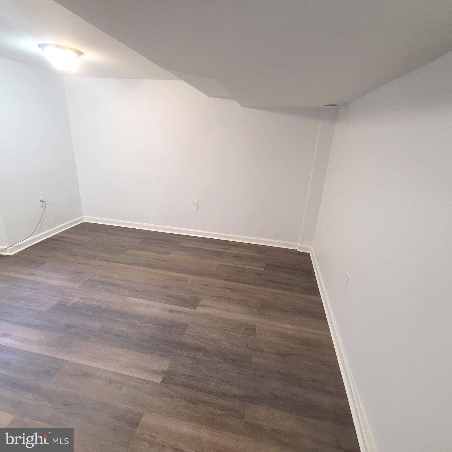 4603 Marble Hall Road Baltimore, MD 21239 - Photo 17 of 24 a view of an empty room with wooden floor