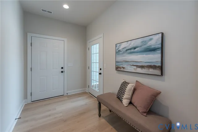 a living room with furniture and a painting