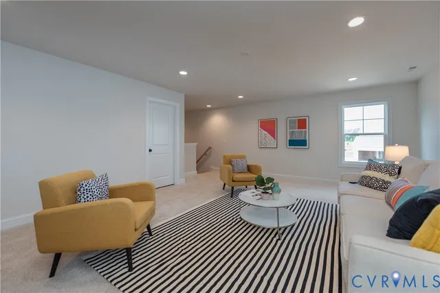 a living room with furniture and a chair