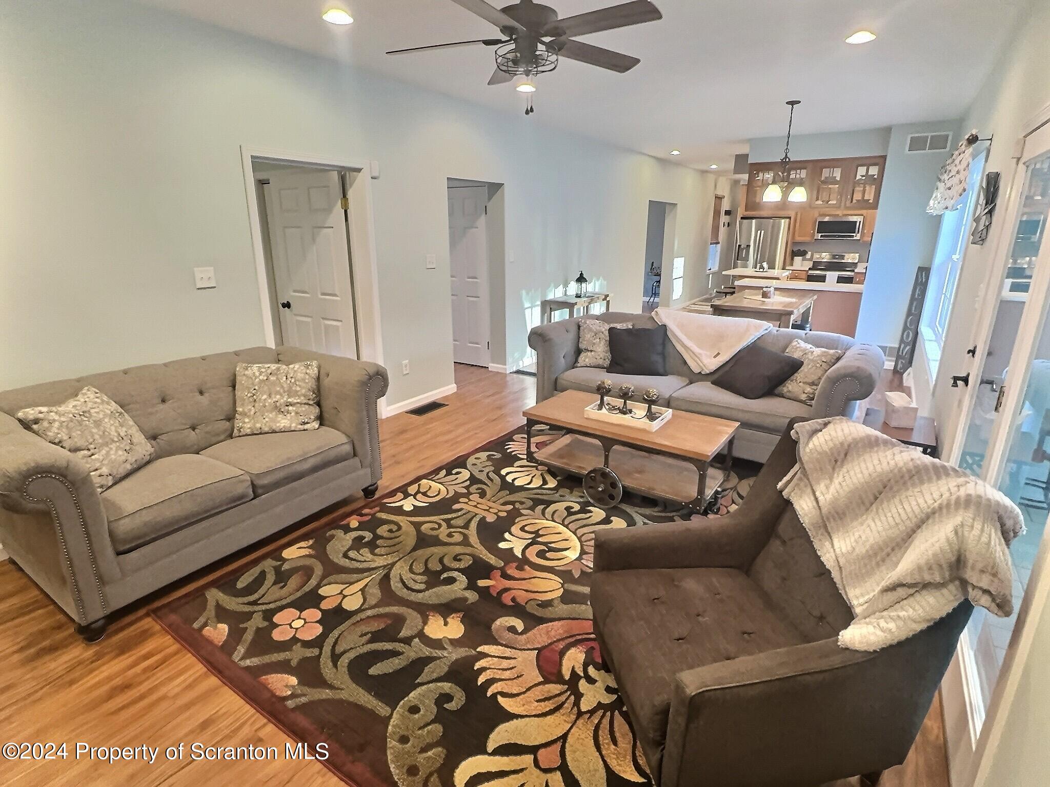 514 Brace Road Dallas, PA 18612 - Photo 11 of 49 a living room with furniture and a chandelier