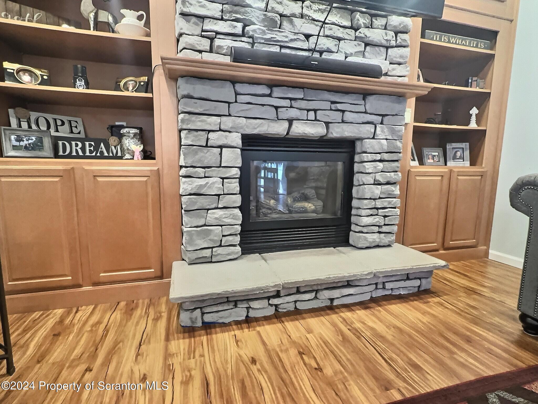 514 Brace Road Dallas, PA 18612 - Photo 12 of 49 a living room with hard wood floors and a fireplace