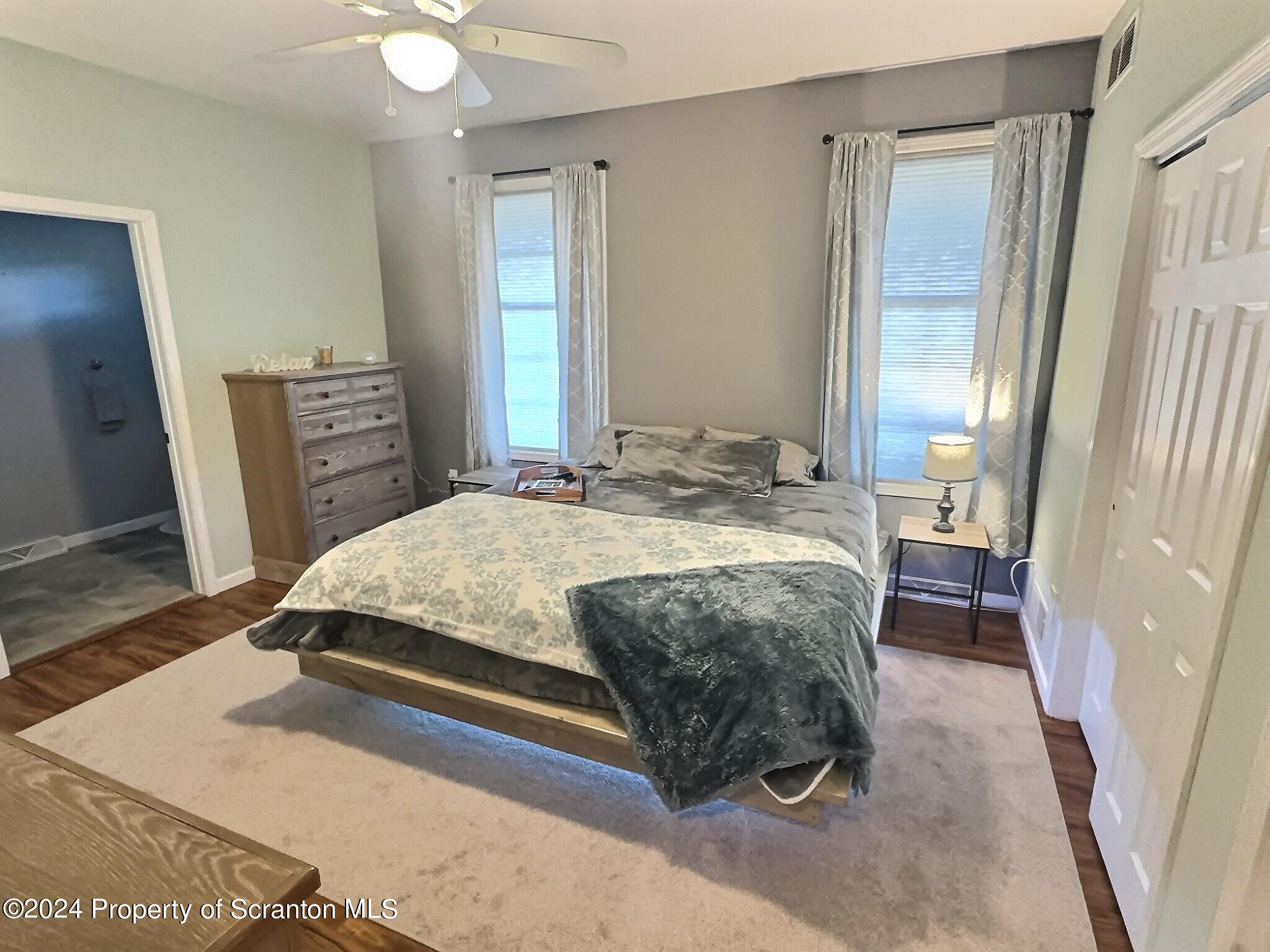 514 Brace Road Dallas, PA 18612 - Photo 20 of 49 a bedroom with a bed and a flat tv screen on dresser
