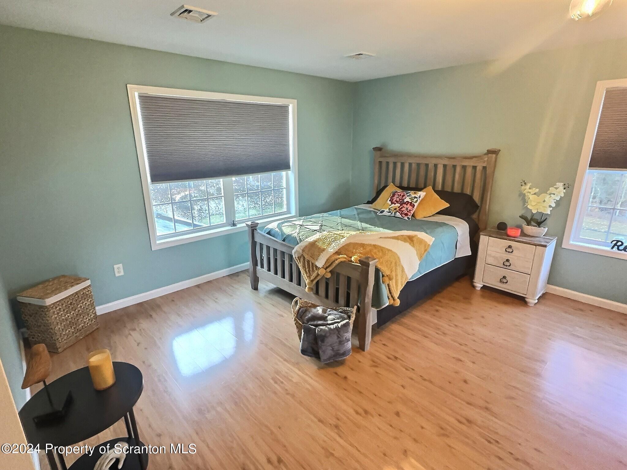 514 Brace Road Dallas, PA 18612 - Photo 24 of 49 a bedroom with a bed and a chair
