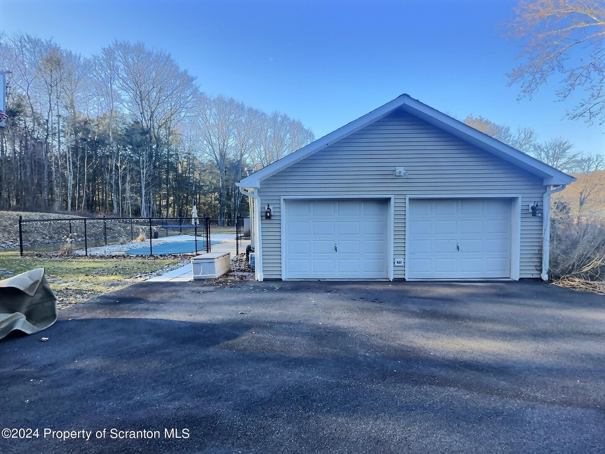 514 Brace Road Dallas, PA 18612 - Photo 47 of 49 a view of a house with a yard and garage