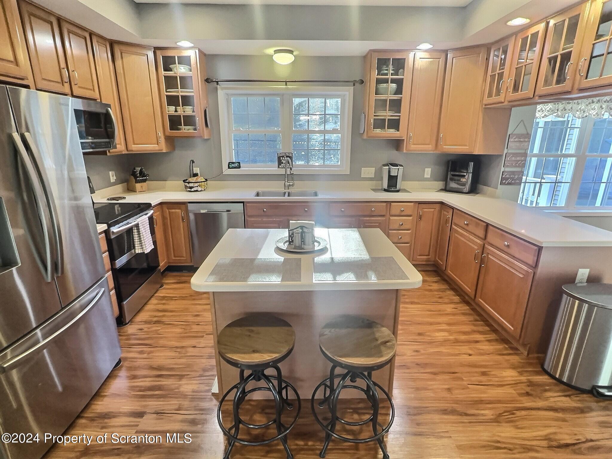 514 Brace Road Dallas, PA 18612 - Photo 5 of 49 a kitchen with stainless steel appliances granite countertop a table chairs a refrigerator and a sink