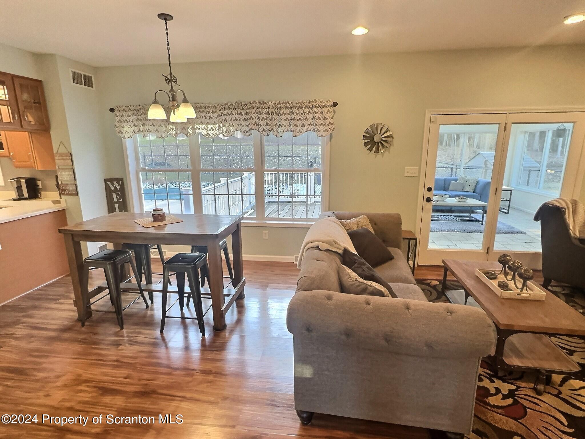 514 Brace Road Dallas, PA 18612 - Photo 9 of 49 a living room with furniture wooden floor and a chandelier