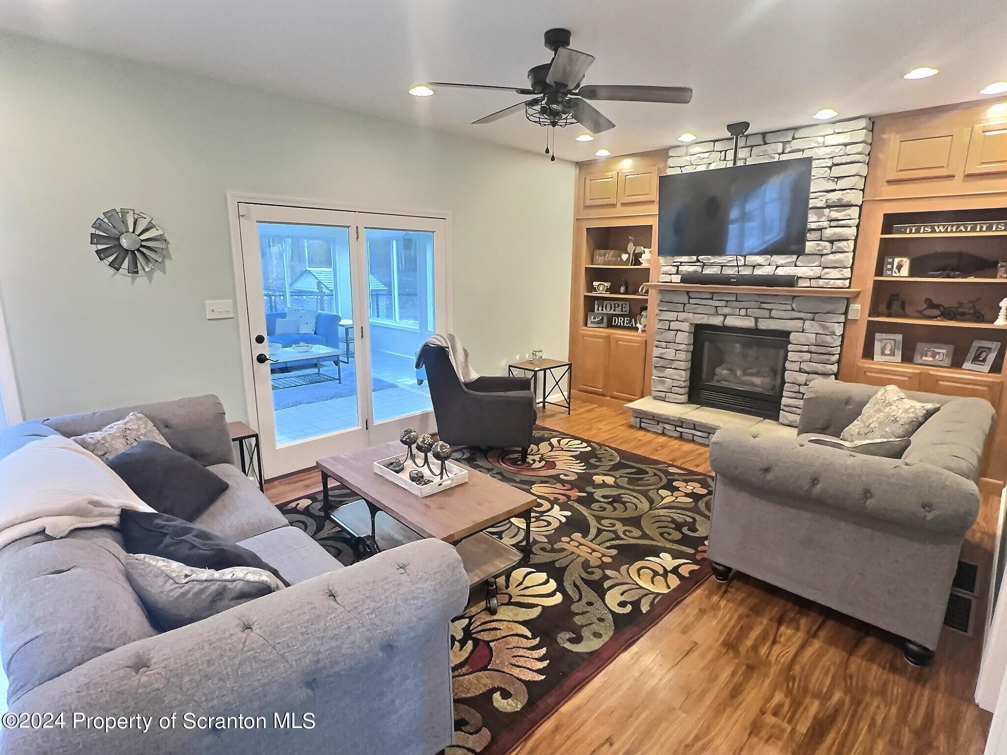 514 Brace Road Dallas, PA 18612 - Photo 10 of 49 a living room with furniture a fireplace and a flat screen tv