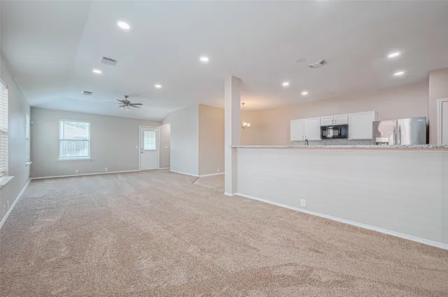 a view of a kitchen with a refrigerator and a window