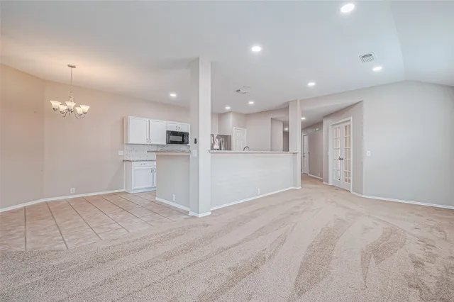 a view of kitchen with refrigerator and window