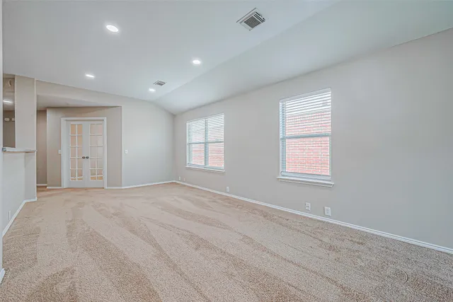 an empty room with windows and closet