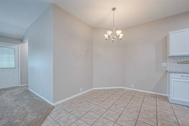 a view of a chandelier in big room and chandelier