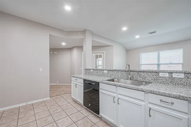 a view of a sink and a refrigerator in a room