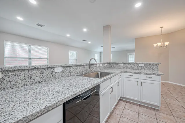 a kitchen with a sink and cabinets