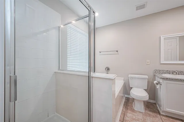 a bathroom with a toilet a sink and a shower