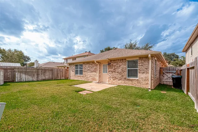 a big house with a big yard and large trees