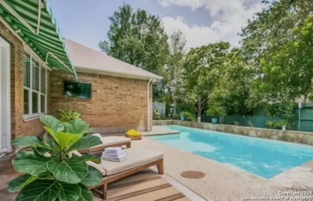 a view of backyard with a garden and seating area