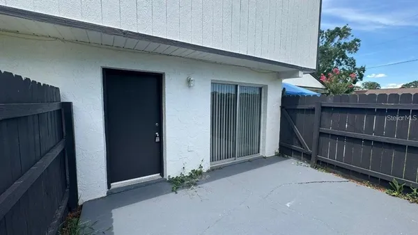 an empty room with plants and wooden fence