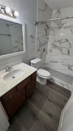 a bathroom with a sink toilet and shower
