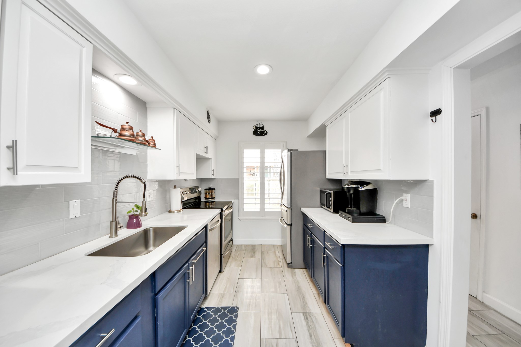 12757 Huntingwick Drive, Unit 142 Houston, TX 77024 - Photo 12 of 36 Updated kitchen featuring white cabinetry, stainless steel appliances, and a clean, modern look.