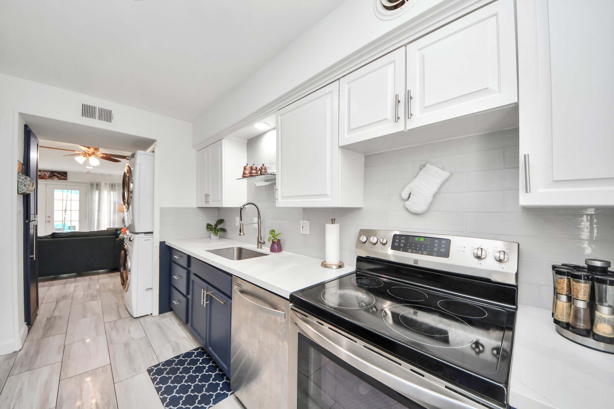 12757 Huntingwick Drive, Unit 142 Houston, TX 77024 - Photo 14 of 36 Modern kitchen offering ample cabinetry, sleek countertops, and stainless steel appliances.