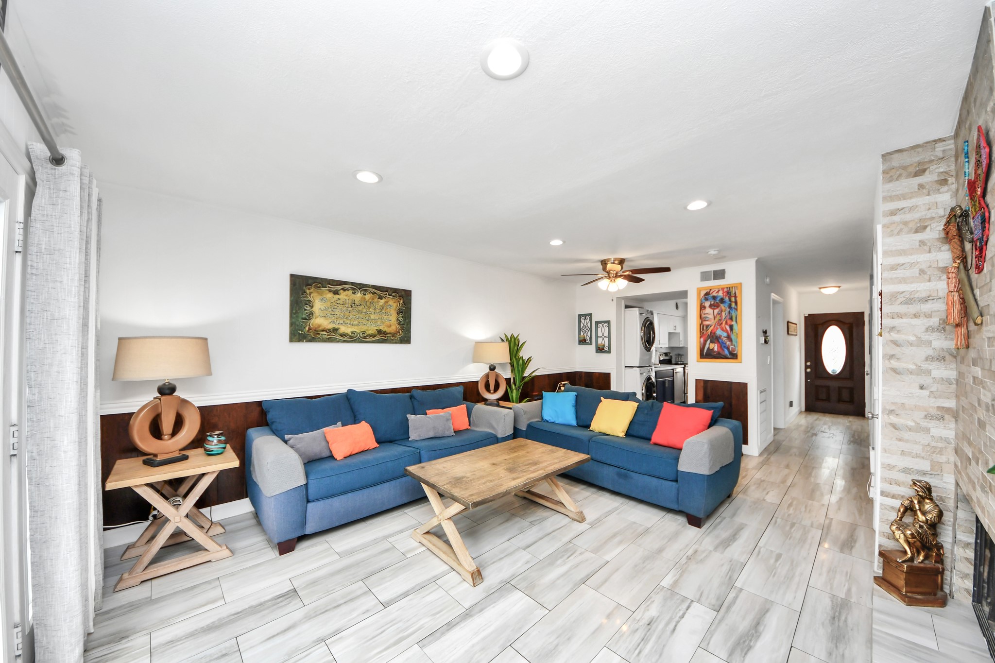 12757 Huntingwick Drive, Unit 142 Houston, TX 77024 - Photo 20 of 36 Open living and dining area offering a comfortable layout, ceiling fan, and abundant natural light.