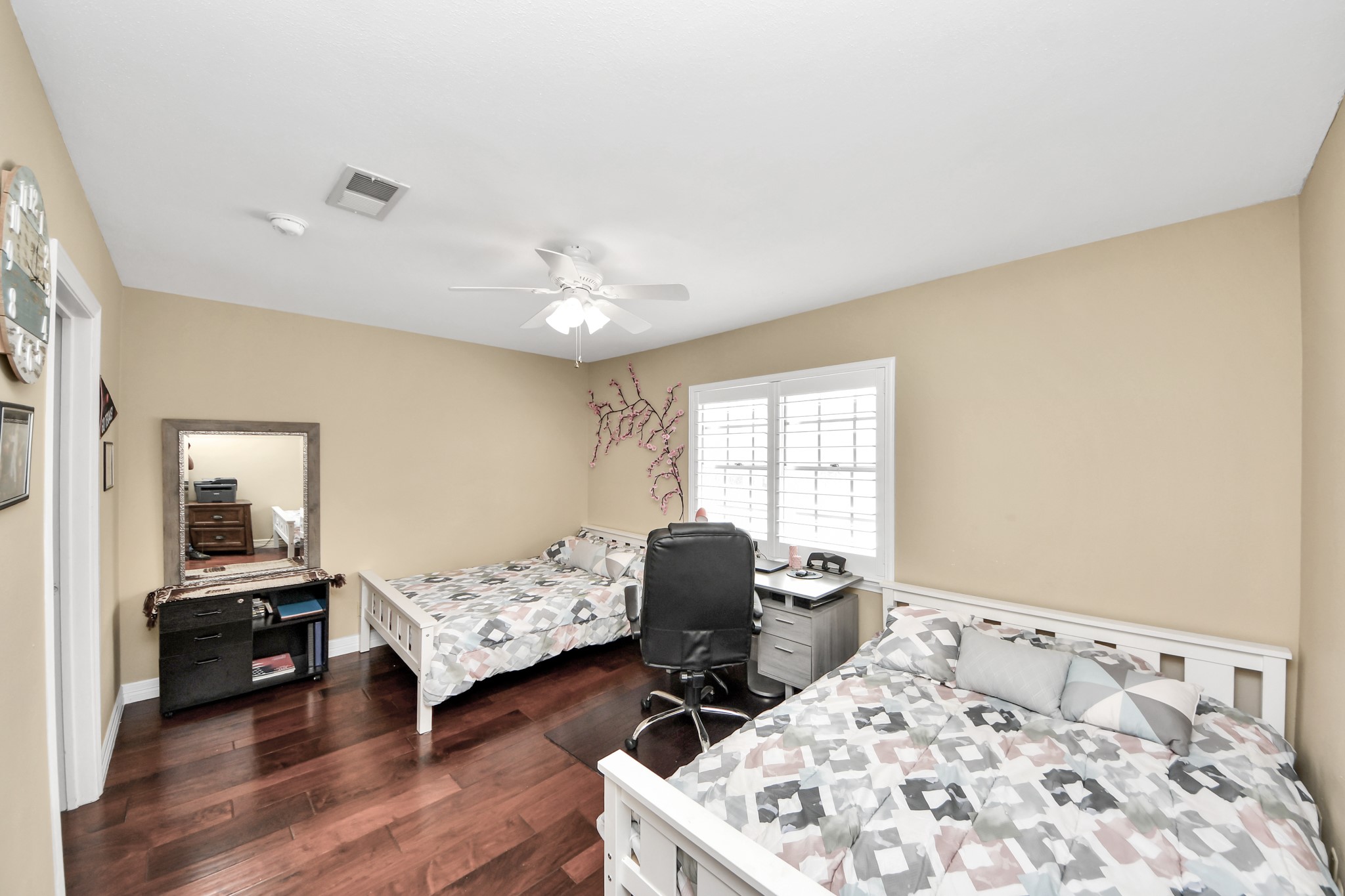 12757 Huntingwick Drive, Unit 142 Houston, TX 77024 - Photo 25 of 36 Spacious bedroom offering ample room for two beds, featuring window shutters and abundant natural light.