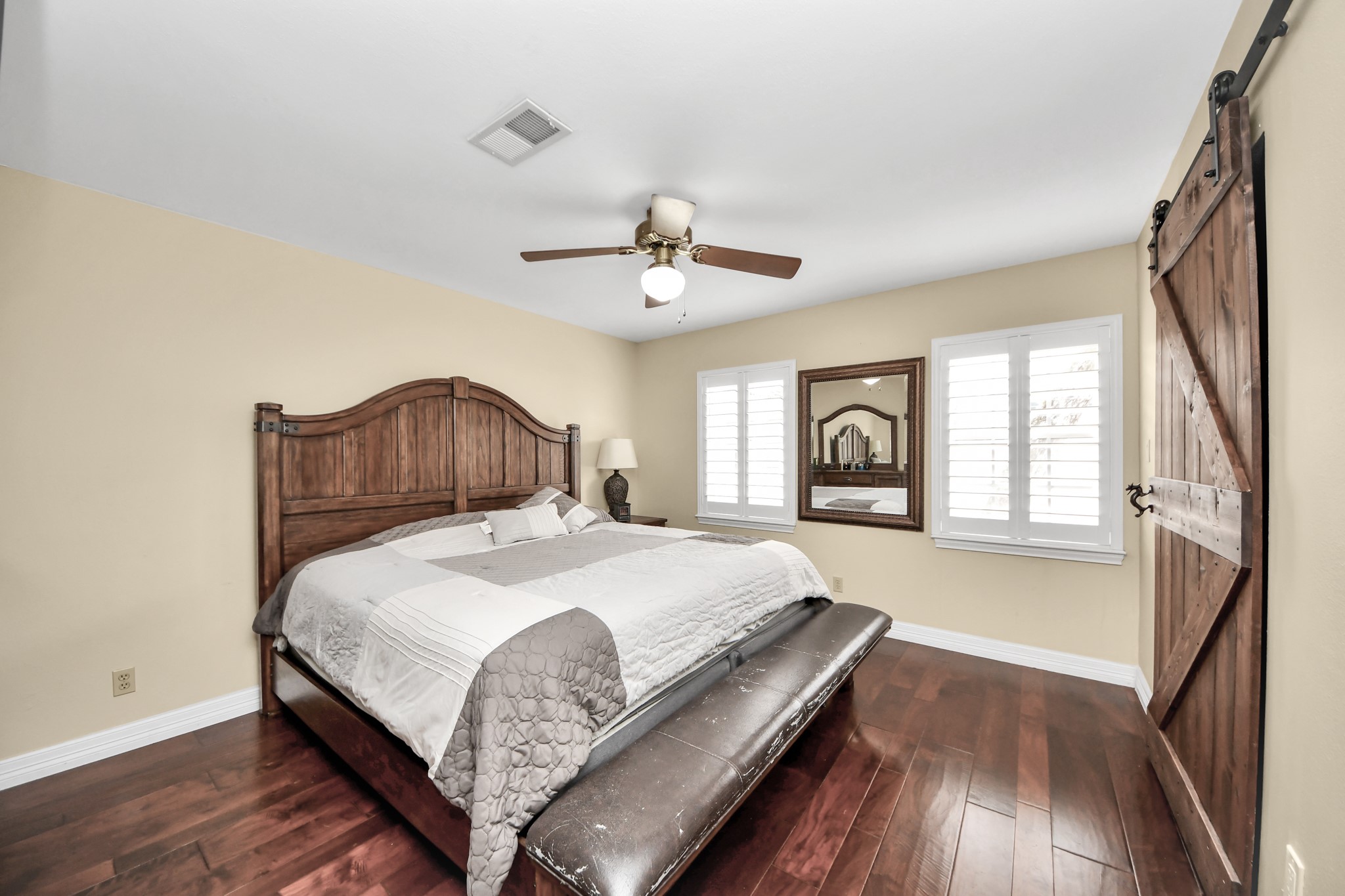 12757 Huntingwick Drive, Unit 142 Houston, TX 77024 - Photo 29 of 36 Well-sized primary bedroom with engineered wood flooring, ceiling fan, and a relaxing atmosphere.