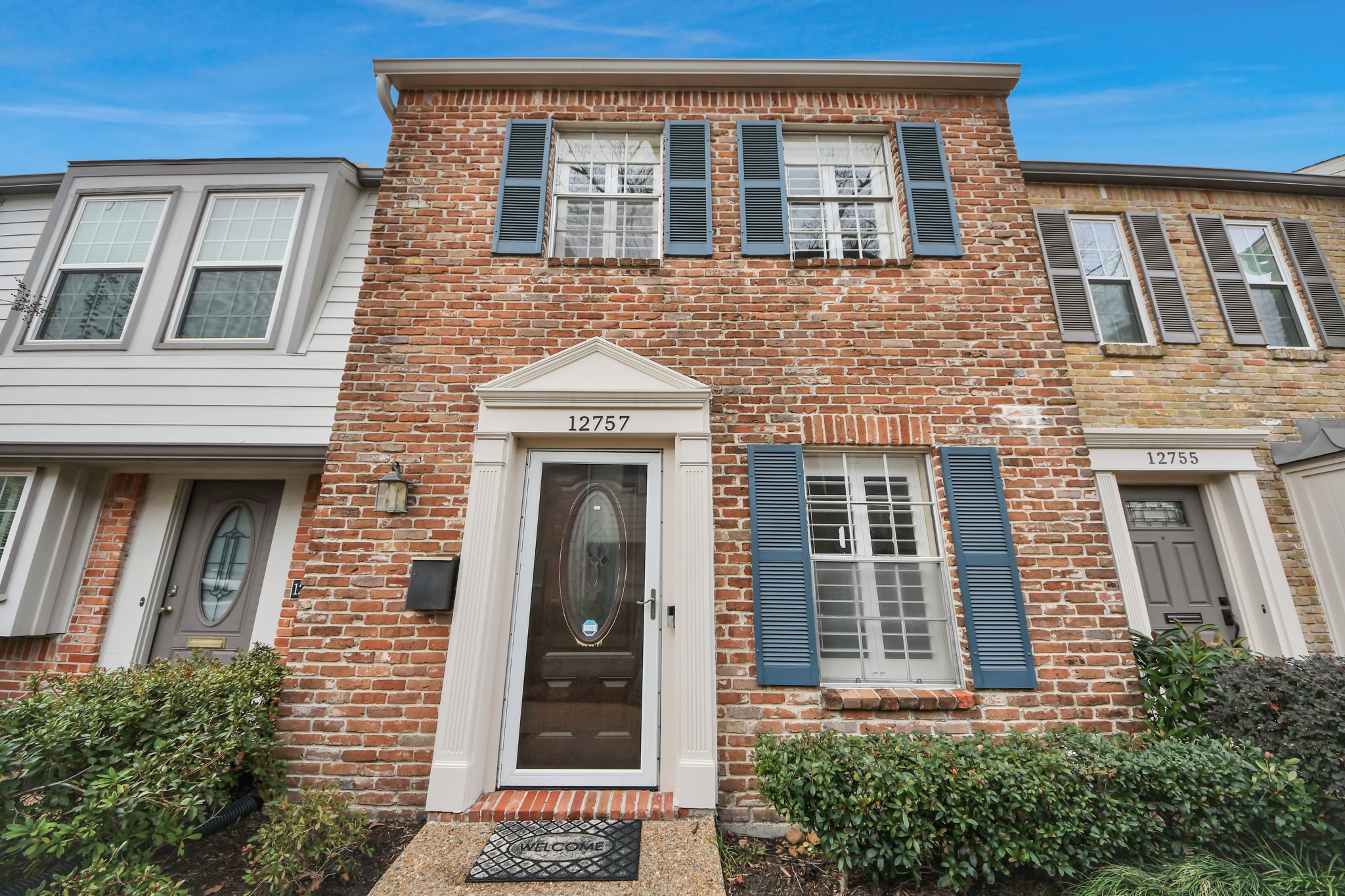 12757 Huntingwick Drive, Unit 142 Houston, TX 77024 - Photo 3 of 36 Charming brick-front condominium with symmetrical design, accented by shuttered windows that enhance its curb appeal.