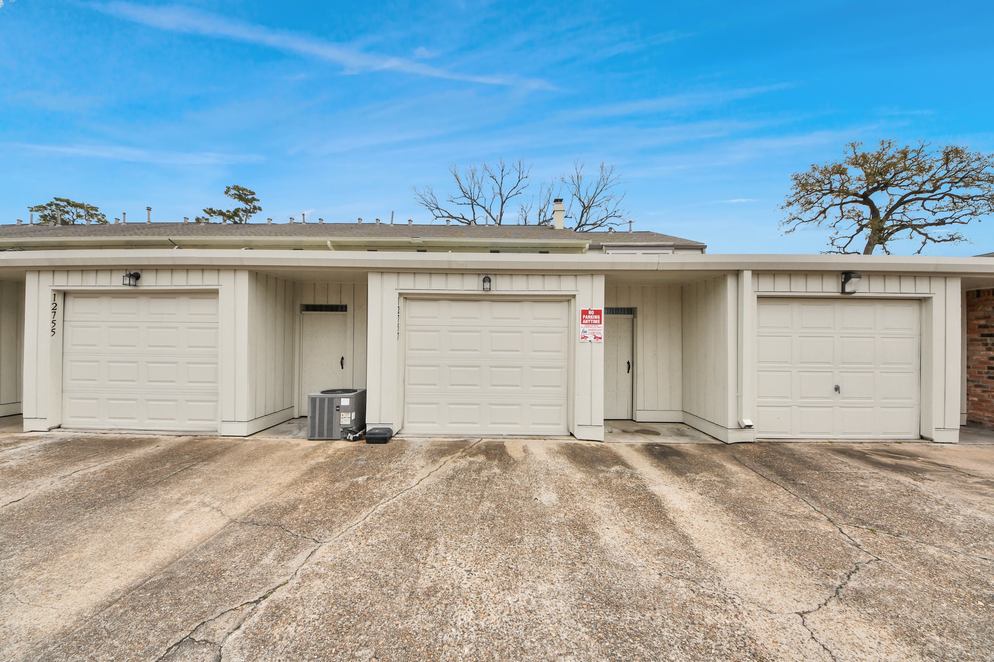 12757 Huntingwick Drive, Unit 142 Houston, TX 77024 - Photo 35 of 36 View from the garage area showcasing a clean, well-maintained community setting.