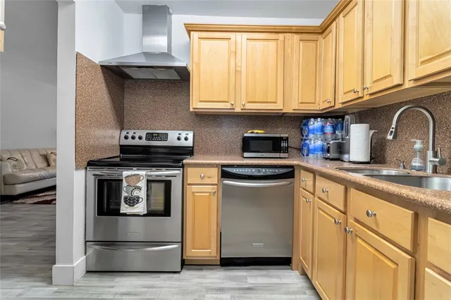 a kitchen with stainless steel appliances granite countertop a stove and a microwave